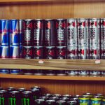 a shelf with many cans of beer on it