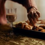 clear glass flute with liquid near pastries on tray